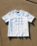 Get a Grip Tee flat lay on concrete