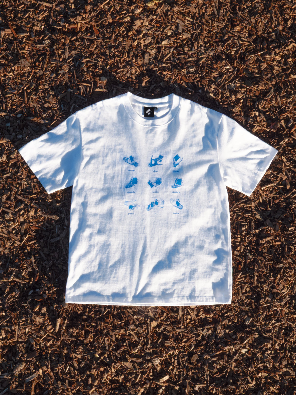 Get a Grip Tee flat lay on mulch