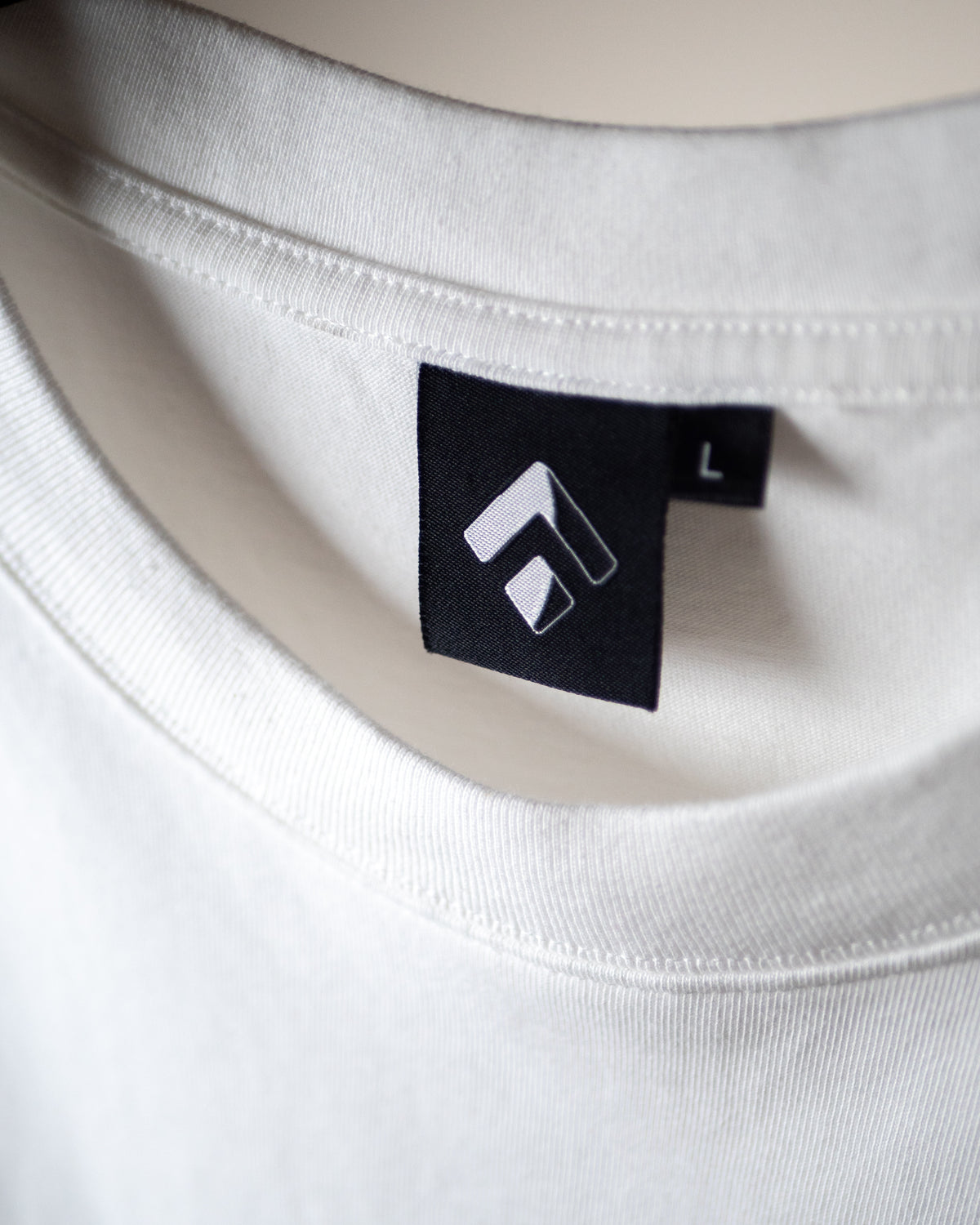 Squareup neck tag on the Get a Grip Tee